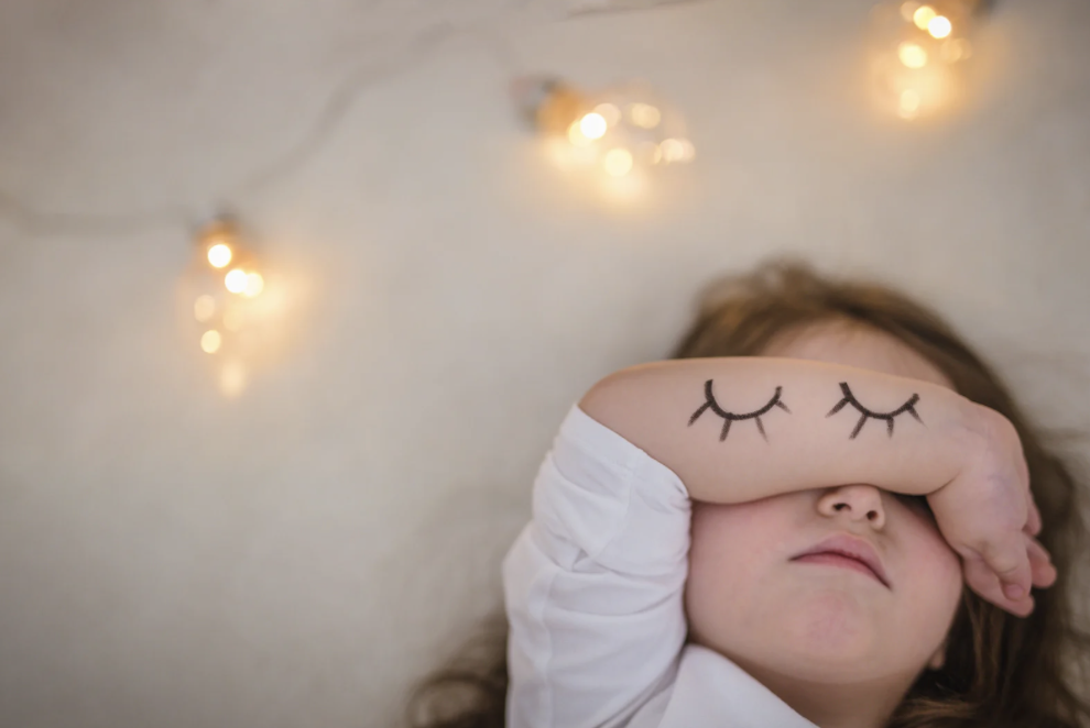 Child with sleep mask resting peacefully - rebuilding sleep after regression and life changes with gentle support